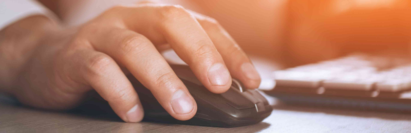 Man clicking on a mouse.