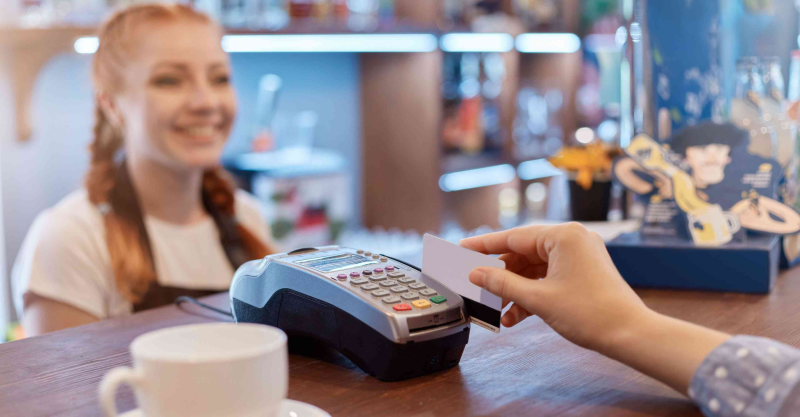 Woman receiving payment at a retail store.